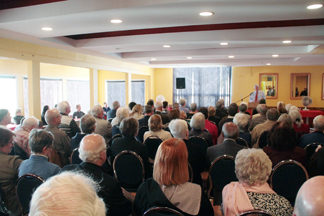 Guests listen to the reading.